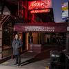 A man stands in front of John’s of 12 Street in New York. 