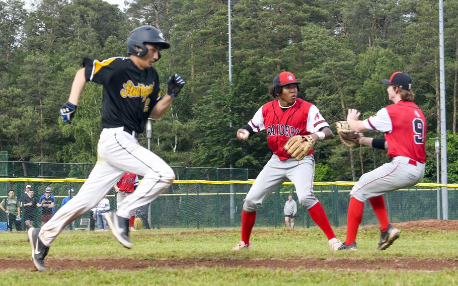 Kaiserslautern pitcher Rueben Todman and teammate Braydon Lokey look at each other with neither covering first base as Stuttgart’s Tyler Blalock races to first on a grounder that loaded the bases in what would be a close 6-5 loss during the knockout rounds of the 2024 DODEA European baseball championships on May 23, 2024, at Southside Fitness Center on Ramstein Air Base, Germany.