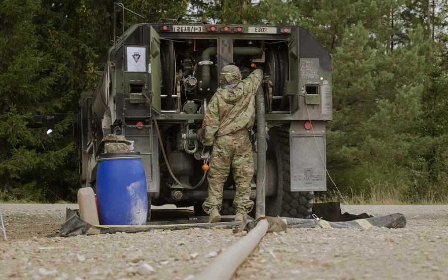 A soldier with the 12th Combat Aviation Brigade operates a fueling truck that allows multiple Apache helicopters to refuel before their flight over Grafenwoehr Training Area in Germany on Sept. 24, 2024. 