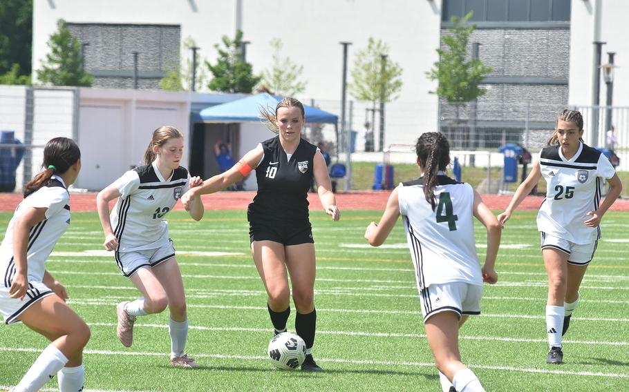 Stuttgart's Ella Kirk tries to navigate through a host of SHAPE defenders in the Panthers' 5-0 victory Monday, May 20, 2024, at the DODEA European Division I girls soccer championships at Ramstein High School.