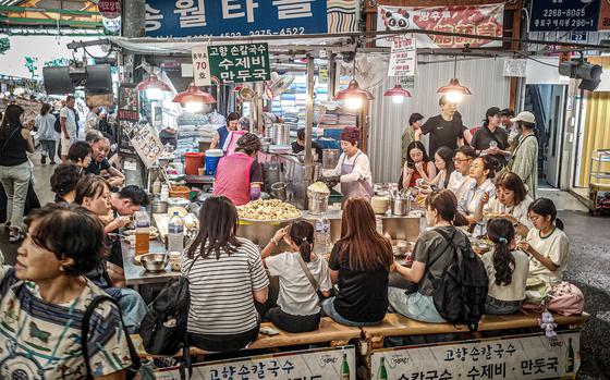 Customers eat at a food stand inside Gwangjang Market in Seoul, South Korea, Sept. 19, 2024. 