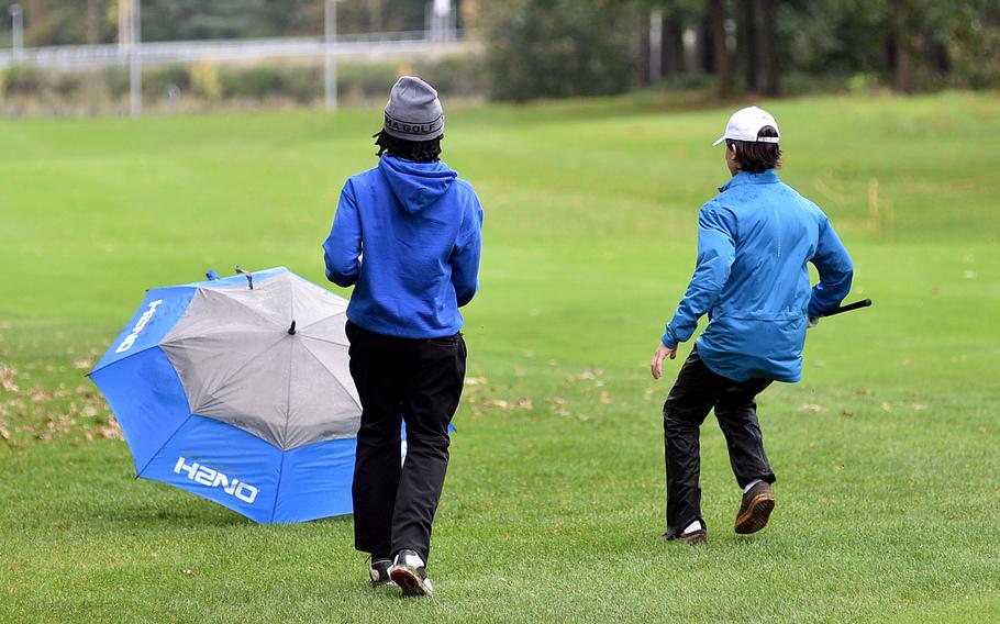 Players chase after an umbrella.