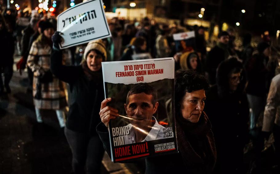 Protesters in Jerusalem on Wednesday, Jan. 24, 2024, hold up signs for hostages in Gaza during a march organized by women’s groups meant to raise awareness about the plight of female hostages.