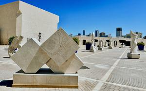 Sculptures made of white travertine line the walkway leading to the Bahrain National Museum in Manama.