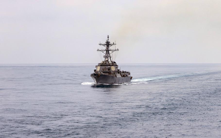 A guided-missile destroyer sails in the open sea.