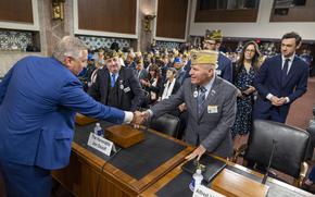 Rep. Mike Bost, R-Ill., left, shakes hands with Commander-in-Chief Alfred J. "Al" Lipphardt, Veterans of Foreign Wars of the U.S. on Tuesday, March 4, 2025, before a Joint House and Senate Veterans Affairs committee hearing in Washington. (Eric Kayne/Stars and Stripes)