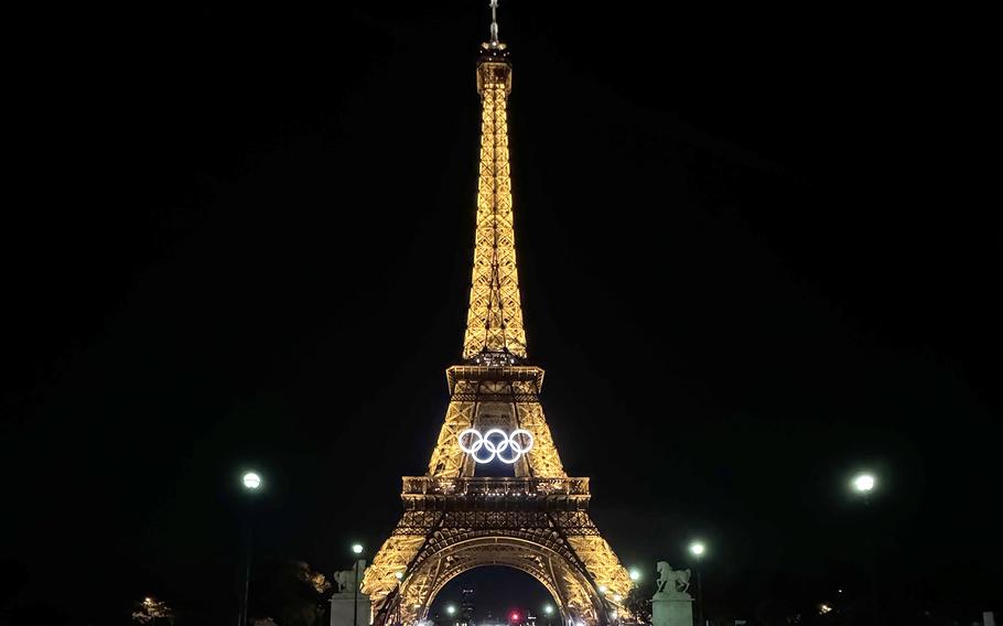 The Eiffel Tower in Paris, France, seen at night with the Olympic rings on the front.