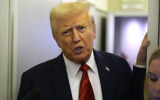 President Donald Trump speaks to reporters aboard Air Force One en route from Miami to Joint Base Andrews, Md., Monday, Jan. 27, 2025. (AP Photo/Mark Schiefelbein)