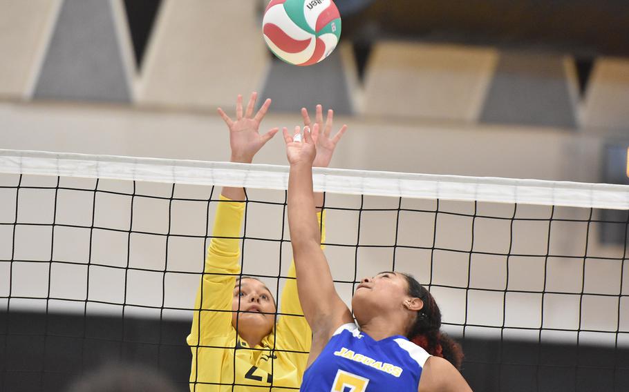 Vicenza's Yaneli Tellez stretches to block while Sigonella's Nyeema Fernandez gets set to tip the ball over the net Friday, Sept. 13, 2024, in Vicenza, Italy.