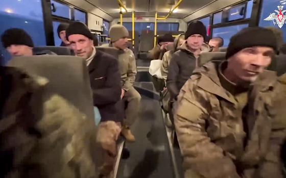 In this photo taken from video released by the Russian Defense Ministry Press Service on Monday, Dec. 30, 2024, a group of Russian soldiers sit in a bus after being released in a prisoners swap between Russia and Ukraine, at an unspecified location in Belarus. (Russian Defense Ministry Press Service via AP)