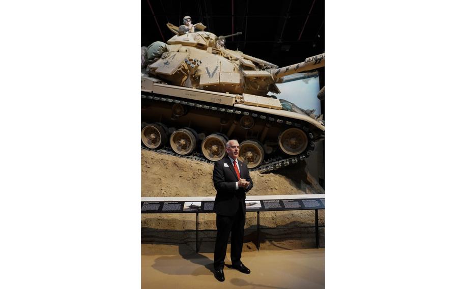 Deputy Director David Vickers speaks to press members in front of the M60A1 tank at the National Museum of the Marine Corps.