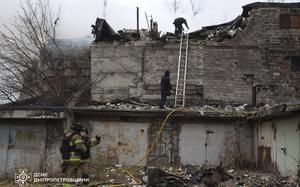 In this photo provided by the Ukrainian Emergency Services on Nov. 21, 2024, rescue workers put out a fire of a building which was heavily damaged by a Russian strike on Dnipro, Ukraine. (Ukrainian Emergency Service via AP)