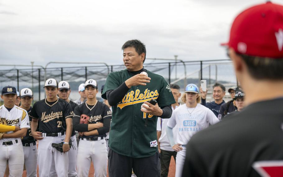 Former Major League pitcher Keiichi Yabu, now a coach for Japan’s Hanshin Tigers, instructs American and Japanese high school players during a clinic at Yokosuka Naval Base, Japan, May 12, 2024.