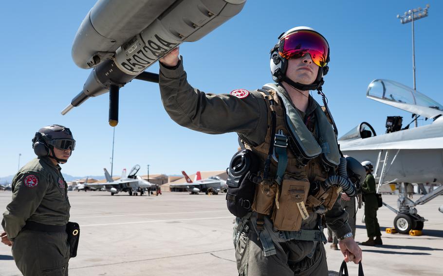 Two airmen conduct an inspection on an aircraft