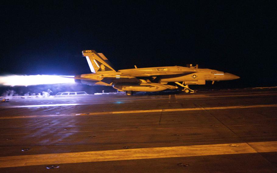 A jet takes off from an aircraft carrier.