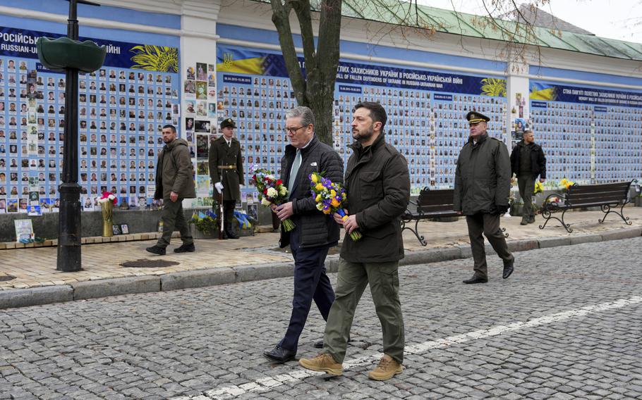 British Prime Minister Keir Starmer and Ukrainian President Volodymyr Zelenskyy arrive to lay wreaths at The Wall of Remembrance of the Fallen for Ukraine, in Kyiv, Ukraine Thursday, Jan. 16, 2025. 