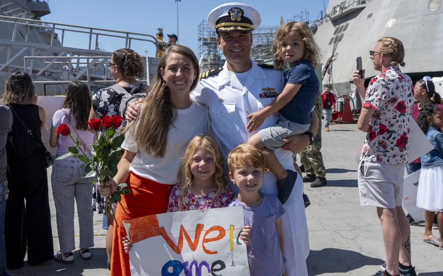 Cmdr. Matthew G. Farrell, poses for a photo with loved ones 