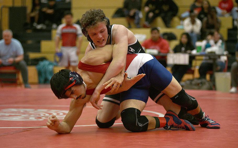Lakenheath's Lucius Bowman fights out of a hold by AFNORTH's Markuss Grebesz during the 165-pound final at a wrestling meet on Dec. 9, 2023, at Kaiserslautern High School in Kaiserslautern, Germany.