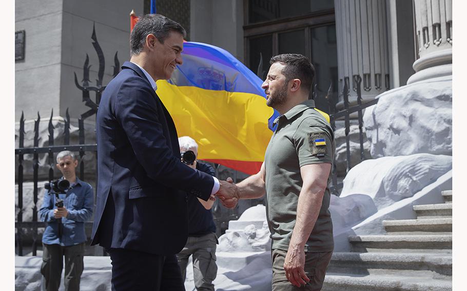 Ukrainian President Volodymyr Zelenskyy, right, and Spain’s Prime Minister Pedro Sanchez greet each other in Kyiv, Ukraine, on July 1, 2023. 