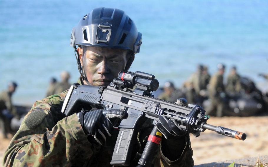 A member of Japan’s Amphibious Rapid Deployment Brigade takes his position on a beach.