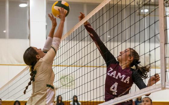 Robert D. Edgren's Kaiya Paison and Zama American's Juliet Bitor battle for the ball during Friday's DODEA-Japan volleyball match. The Trojans won in straight sets.