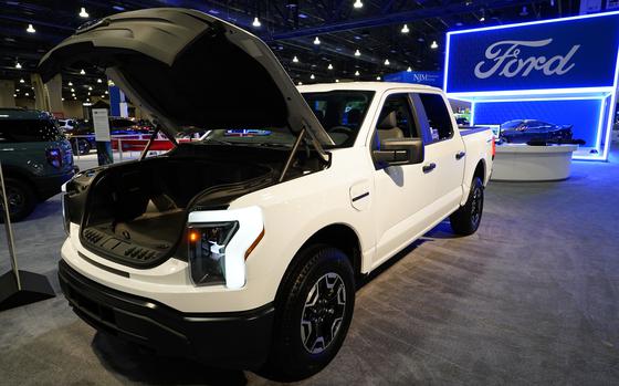 FILE - The Ford F-150 Lightning displayed at the Philadelphia Auto Show, Friday, Jan. 27, 2023, in Philadelphia.  With U.S. electric vehicle sales starting to slow, Ford Motor Co. says, Thursday, April 4, 2024,  it will delay rolling out new electric pickup trucks and a new large electric SUV as it adds gas-electric hybrids to its model lineup.  (AP Photo/Matt Rourke, File)