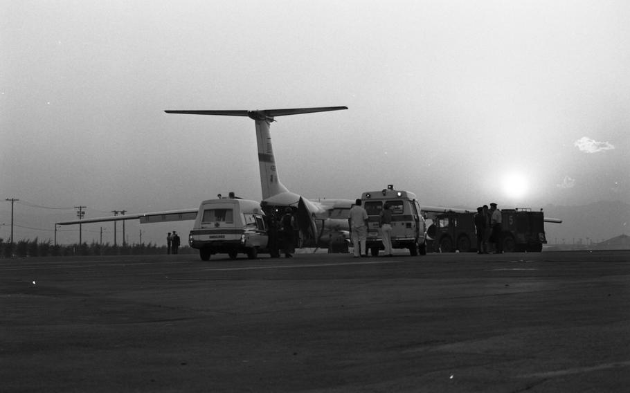 Burn victims from the Camp Fuji fire are loaded at sunset 