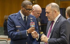 General Randall Reed, USAF, commander of the US Transportation Command, left, fist-bumps Chief of Legislative Affairs Doug Hall, US Transportation Command on Wednesday, March 5, 2025, before Reed testifies , during a Senate Armed Services Committee hearing in Washington. (Eric Kayne/Stars and Stripes)