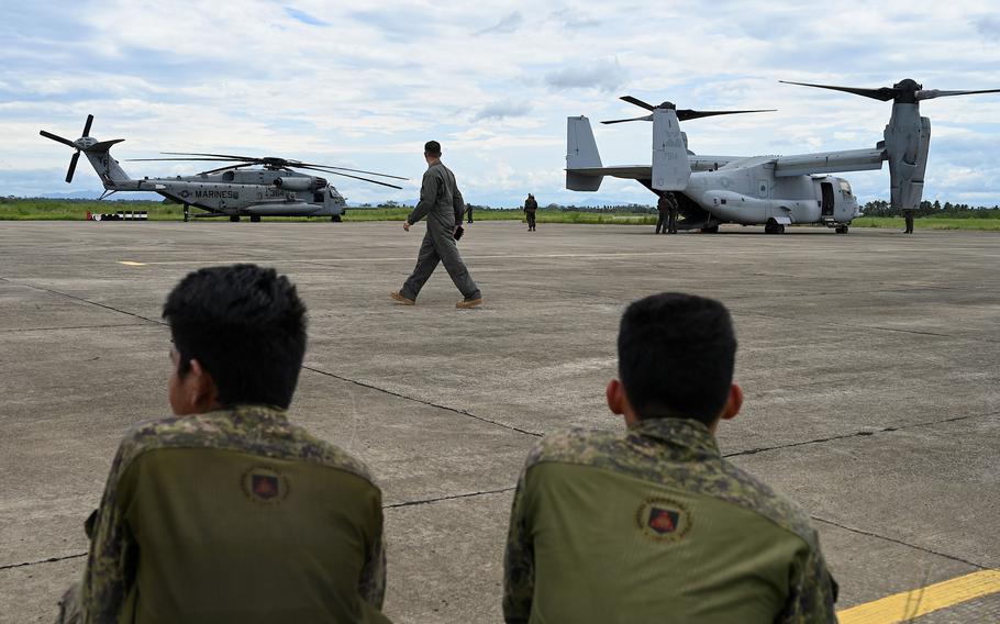 Soldiers watch as a CH53 Sea Stallion helicopter and V-22 Osprey are about to take off, at Lal-lo Air Base on Aug. 3, 2023, in Lal-lo, Cagayan, Philippines. 