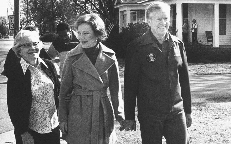 Jimmy Carter holds hands with wife Rosalynn.