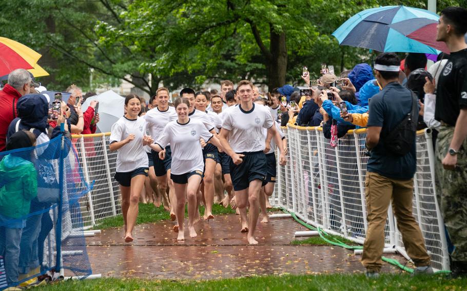 U.S. Naval Academy freshmen, or plebes, from the “Iron Company,” from Sea Trials, lead the plebes as they rush the Herndon monument, a tradition symbolizing the successful completion of the midshipmen’s freshman year. The class of 2027 completed the climb in 2 hours, 19 minutes and 11 seconds. 