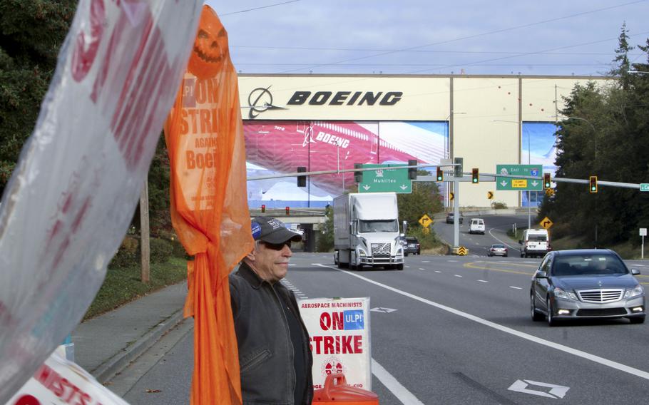 Union machinist Terry Muriekes waves a Halloween-decorated strike sign at Boeing’s Everett, Wash., factory on Oct. 22, 2024.