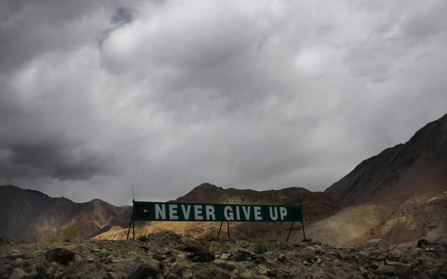 A banner erected by the Indian army stands near Pangong Tso lake near the India-China border in India's Ladakh area in 2017. Top Indian and Chinese army commanders met Saturday, July 31, 2021, after a gap of three months to discuss the expeditious disengagement of thousands of forces in the mountains of the eastern Ladakh region to ease the 15-month border tensions.