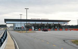 A multi-lane gate for cars on a cloudy day.