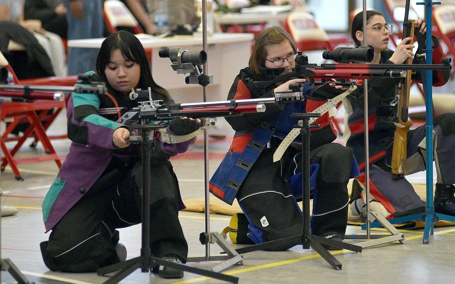 Kaiserslautern shooter Lana Le, left, reloads as teammate Joyce Truschinski aims at the target during a marksmanship competition on Jan. 6, 2024, at Kaiserslautern High School in Kaiserslautern, Germany.