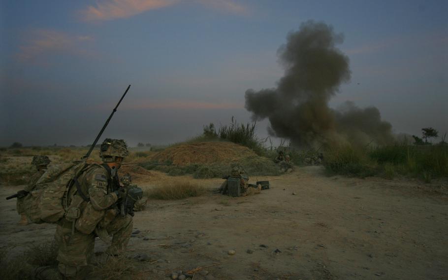 Commander Capt. Dennis Call of Company C, 1st Battalion, 32 Infantry Regiment, 3rd Brigade Combat Team, 10th Mountain Division watches as an anti-personnel obstacle breaching system is blown at dawn.