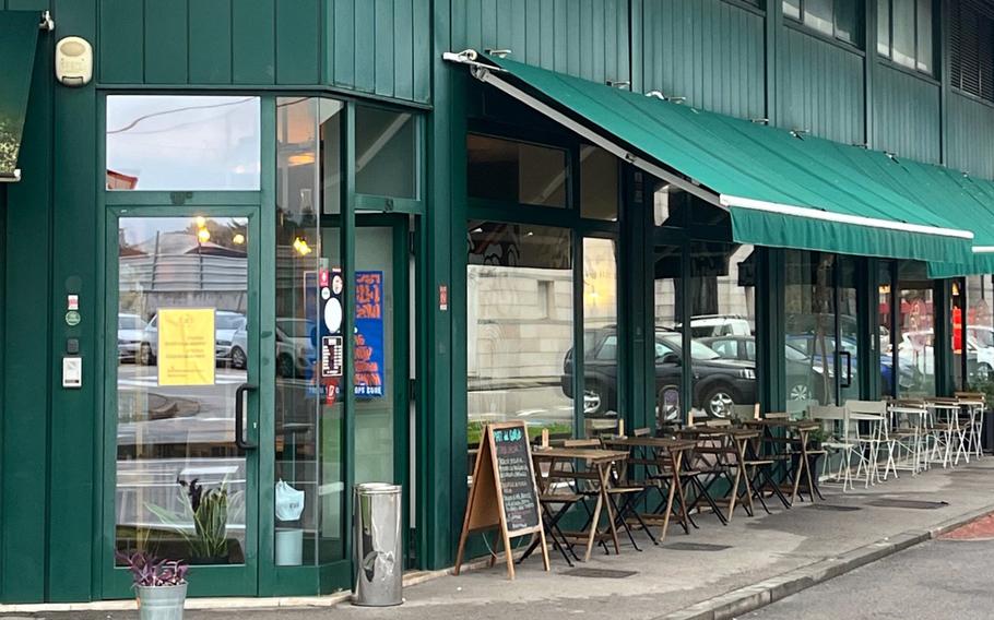 A green awning hangs over the patio of the Il Pastificio restaurant.