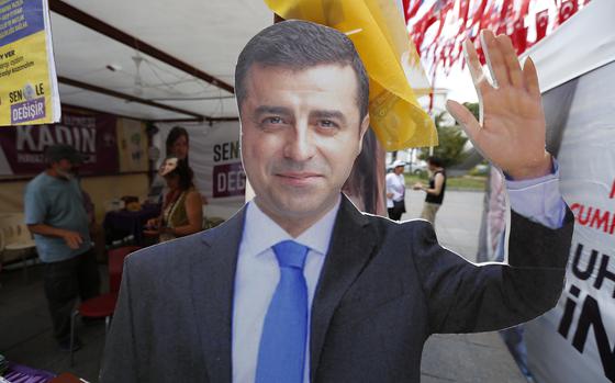 FILE - A cardboard cut-out of Selahattin Demirtas is pictured at an election kiosk in Istanbul, June 20, 2018. (AP Photo/Lefteris Pitarakis, File)