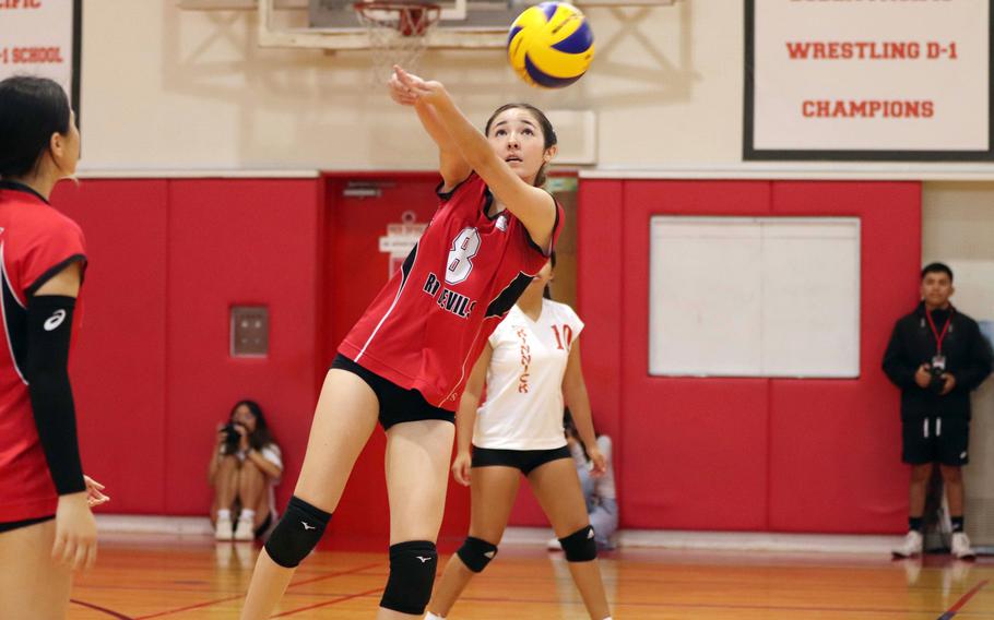 Nile C. Kinnick's Isabella Marchetti bumps the ball during Saturday's DODEA-Japan girls volleyball matches. The Red Devils topped St. Maur in four sets and Robert D. Edgren in three.