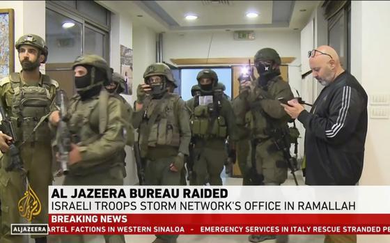 This image made from video provided by Al Jazeera English shows Israeli troops raiding their bureau in Ramallah, West Bank, Sunday, Sept. 22, 2024.