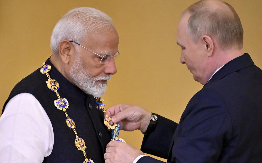 Russian President Vladimir Putin decorates Indian Prime Minister Narendra Modi with the Order of St. Andrew the Apostle the First-Called during a ceremony following their talks at the Kremlin in Moscow on Tuesday, July 9, 2024. (Alexander Nemenov/AFP/Getty Images/TNS)