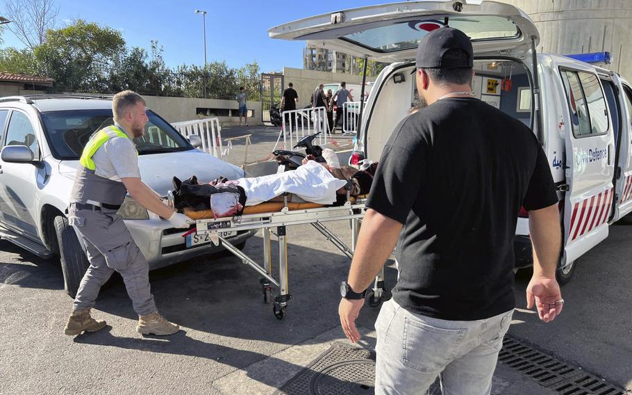 First-responders carry a wounded man