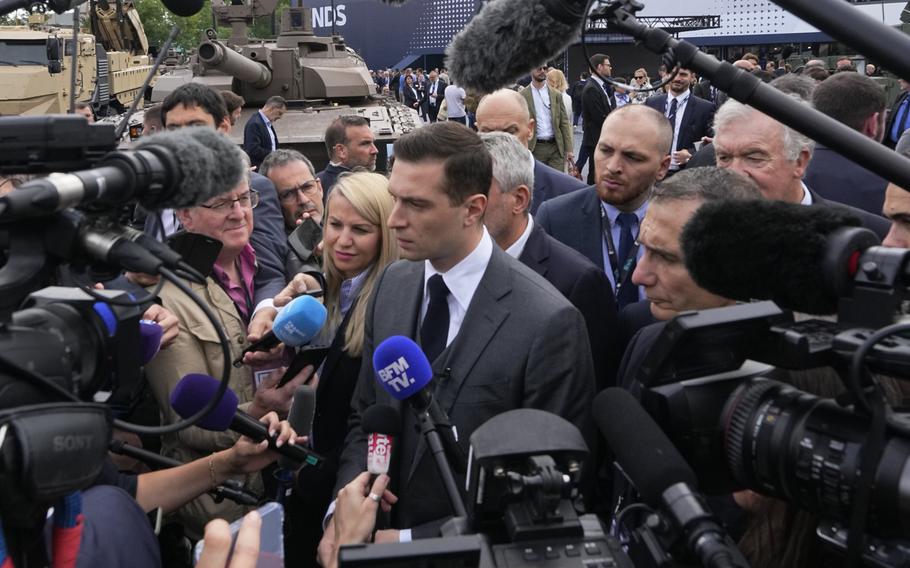 Jordan Bardella, president of the far-right National Front party, answers reporters after visiting the Eurosatory Defense and Security exhibition, Wednesday, June 19, 2024 in Villepinte, north of Paris. Jordan Bardella, hoping to become France’s prime minister, appealed Tuesday to voters to hand his party a clear majority after French President Emmanuel Macron’s announcement on June 9 that he was dissolving France’s National Assembly, parliament’s lower house.