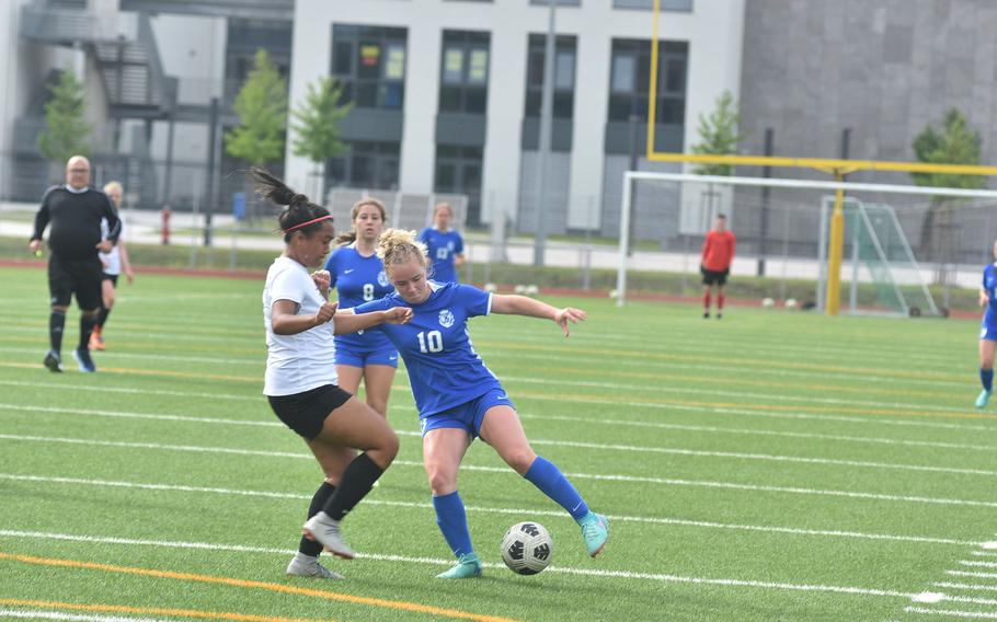 Ramstein's Claire Boynton tries to create some space to operate from Stuttgart's Ayana Gomez on Thursday, May 23, 2024, at the DODEA European Division I girls soccer championships at Ramstein High School in Germany. Boynton scored three times in a 4-1 victory.