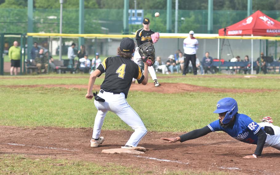 Ramstein's Christian Roy dives back into first before a pickoff throw can reach Stuttgart first baseman Jaxin Schnieders at the DODEA European Division I championship game Friday, May 24, 2024, at Ramstein Air Base, Germany.