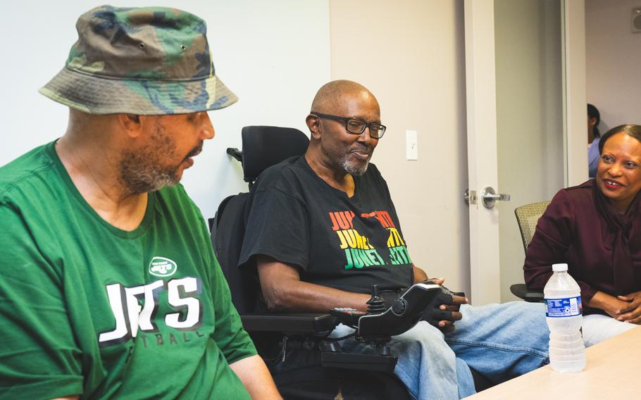 Veterans Richard White, far left, and Michael Chinn speak with HUD Acting Secretary Adrianne Todman about their experiences using a rental assistance voucher program through the Departments of Housing and Urban Development and Veterans Affairs. 