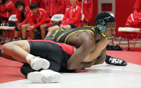 ASIJ''s Cadell Lee pins Kinnick's Sam Tovar at 139 pounds.