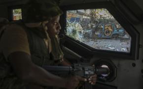 A Kenyan police officer, part of a UN-backed multinational force, patrols a street in Port-au-Prince, Haiti, Dec. 5, 2024. (AP Photo/Odelyn Joseph)