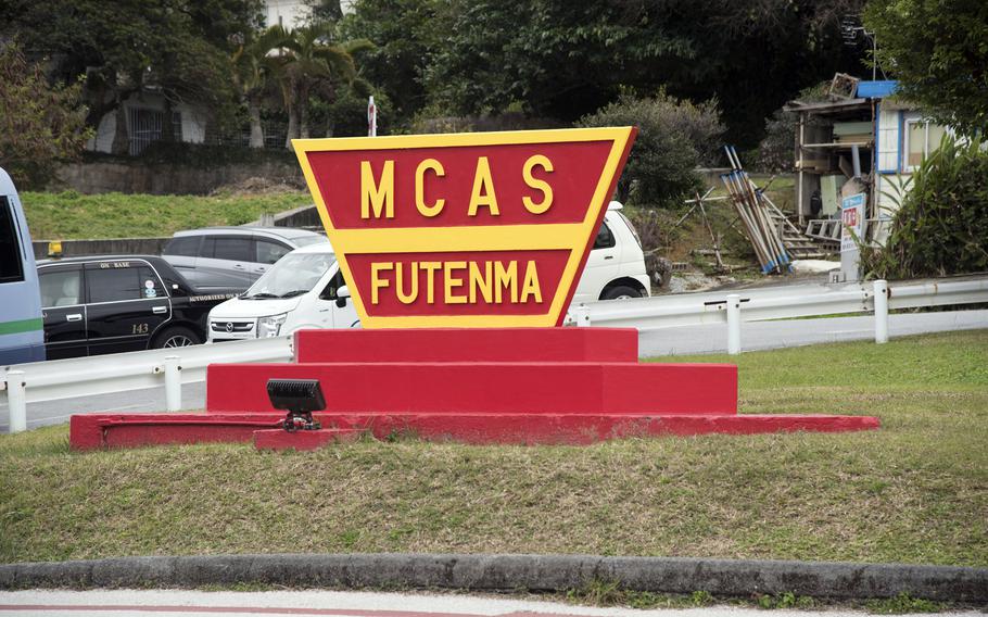 A red and yellow sign says, “MCAS Futenma.”