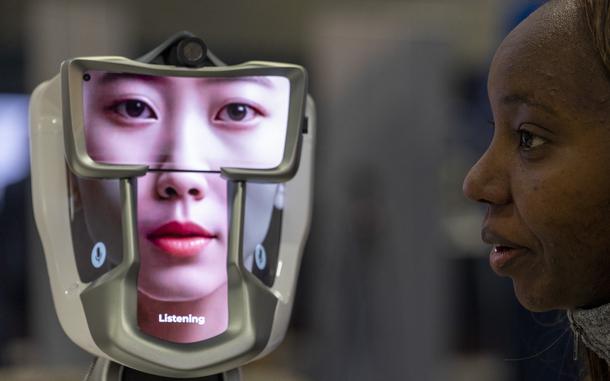 A chatbot on display speaks with a KRH booth attendant during day three of the Association of the United States Army (AUSA) annual meeting, Wednesday, Oct. 16, 2024 in Washington. (Eric Kayne/Stars and Stripes)